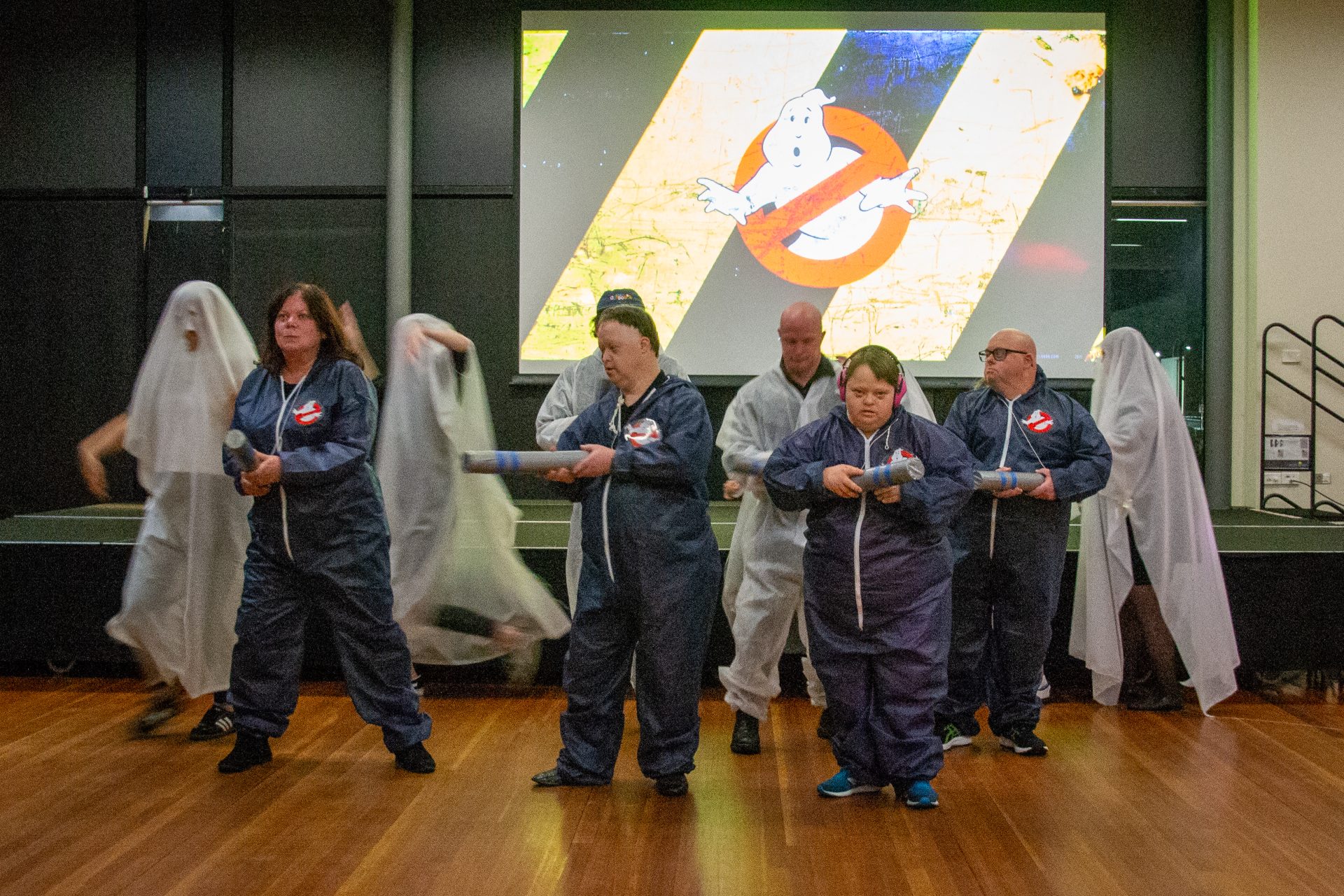 Several people dressed as ghosts and Ghostbusters dancing