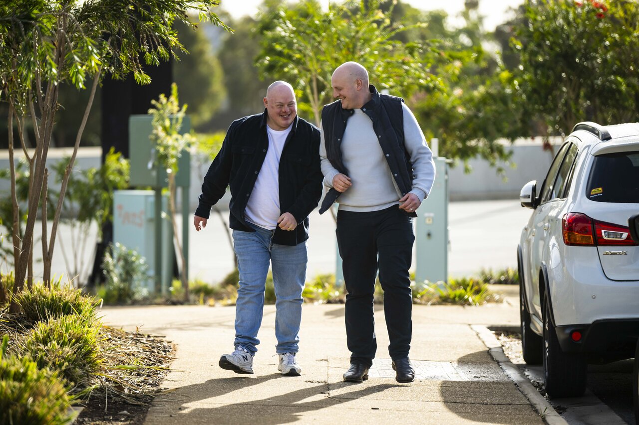 Two brothers walking and laughing together